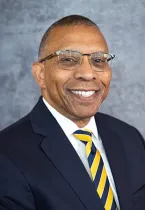 Dr. Laurence Alexander, Chancellor