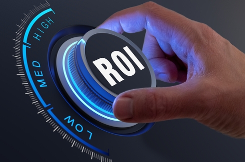 A hand turning a dial labeled ROI