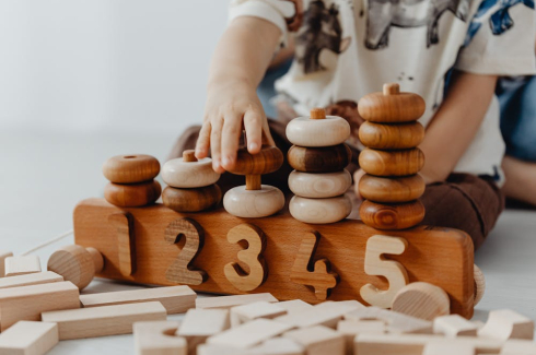 a boy playing with numbered rings