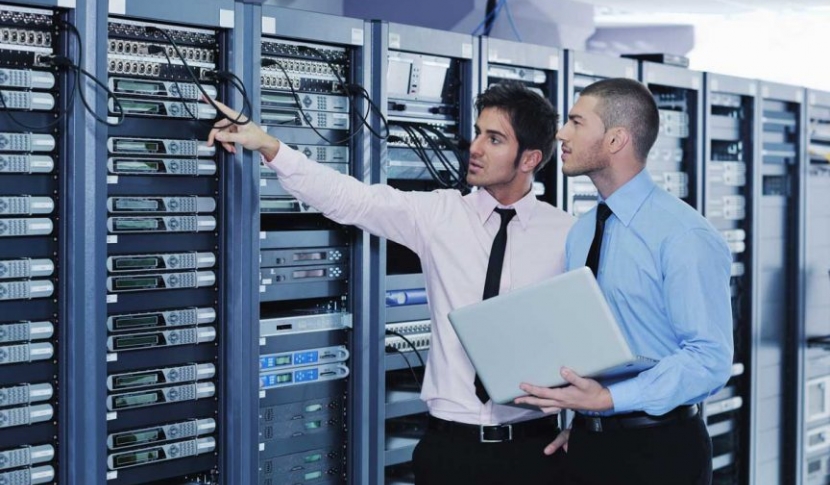 Two men pointing at computer hardware
