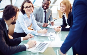 Group gathered around conference table 