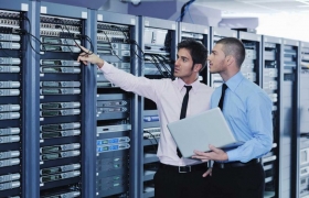 Two men pointing at computer hardware