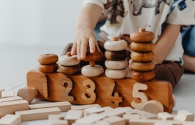 a boy playing with numbered rings